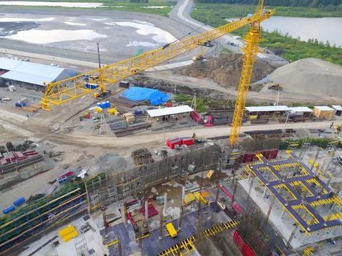 Construction of a hotel with the help of tower cranes, in the mountains against Stock Photos