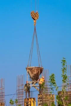 Construction of the house - concrete workers served crane. Stock Photos