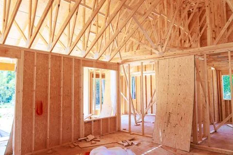 Construction of house interior with wooden frames walls in building site Stock Photos