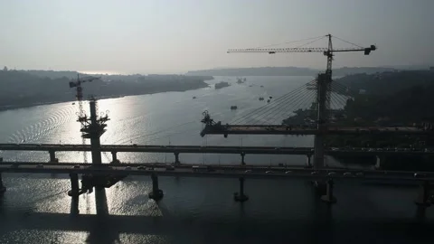 Construction of a huge сable-stayed bridge over the river. Aerial view. Stock-Footage 85530026
