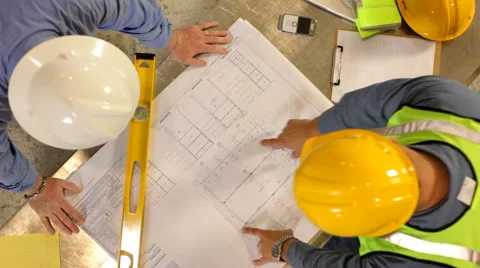 Construction Industry, contractors look over blueprints Stock Footage