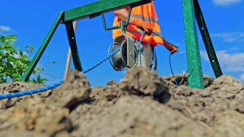 Construction industry on the field. Worker in orange uniform  Stock Footage 134794103