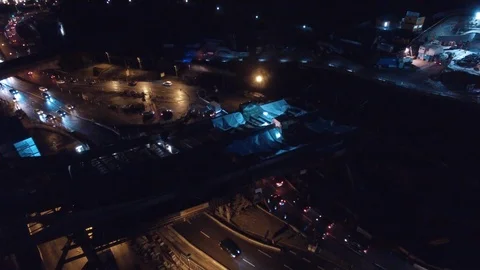 Construction industry fly by night with traffic Stock Footage 104636565