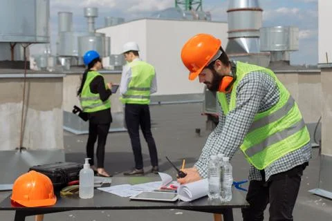 Construction industry group of engineer and architect analyzing the plan of Stock Photos