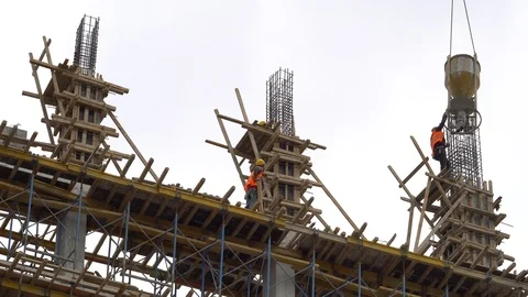 Construction industry workers working on building concrete structure. Stock Footage 85963853