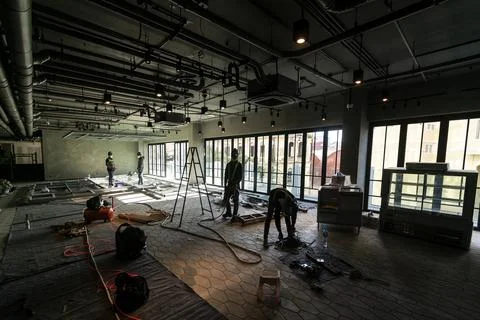 Construction industry workers working inside modern building site in vietnam Stock Photos
