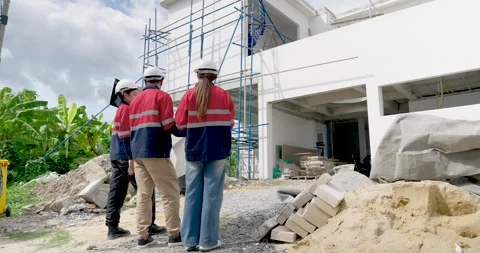 Construction inspection team walks across exterior work zone, asian woman Stock Footage 336226404
