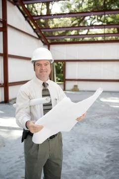 Construction Inspector with Blueprints Stock Photos