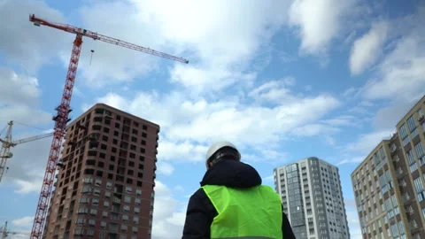 Construction inspector-worker. A male engineer works by inspecting work at a Video stock 171905277