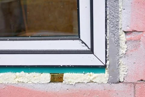 Construction installing.Metal plastic window on pink brick wall Stock Photos