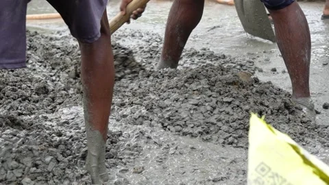 Construction Laborers Mixing Cement and Aggregate for Concrete Work. Stock Footage 337850374