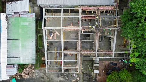 Construction Laborers Working Around Scaffolding and Structural Elements Stock Footage 308045201