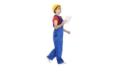 Construction lady using electronic tablet walking on white backg Stock-Fotos