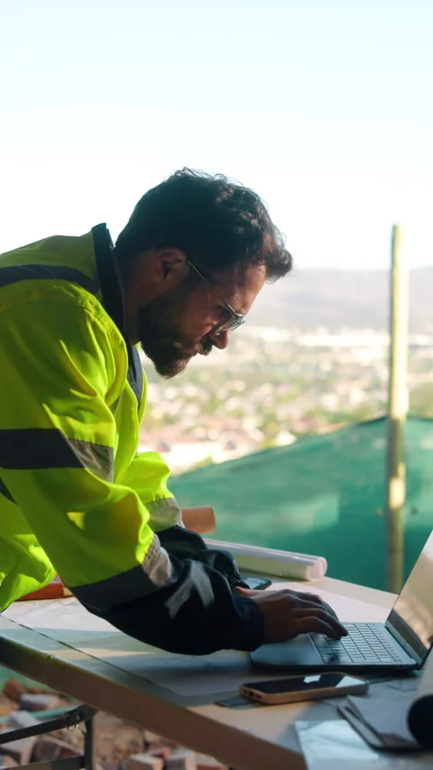 Construction, laptop and typing with man on building site for planning or Stock Footage 336196951