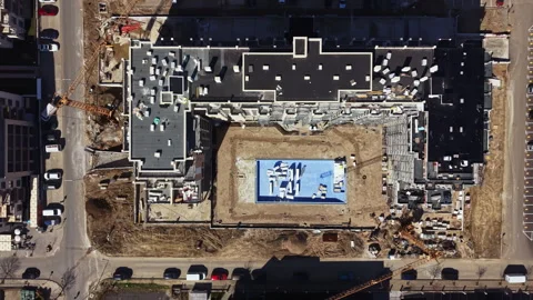 Construction of a large building complex with a swimming pool and cranes in the Stock Footage 335388225