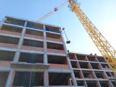 Construction of a large building. Tower crane at a construction site. Stock Photos