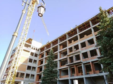 Construction of a large building. Tower crane at a construction site. Stock Photos
