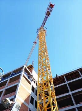 Construction of a large building. Tower crane at a construction site. Stock Photos