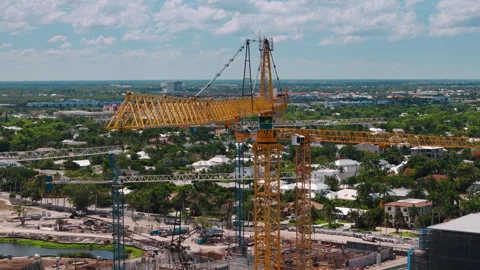 Construction of a large complex using cranes. Aerial drone wide footage of Stock-Footage 297023415