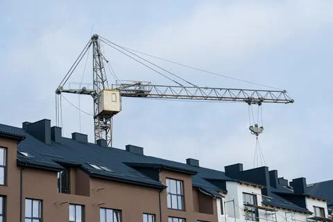 Construction of a large house. Construction crane on the background of the sk Stock Photos