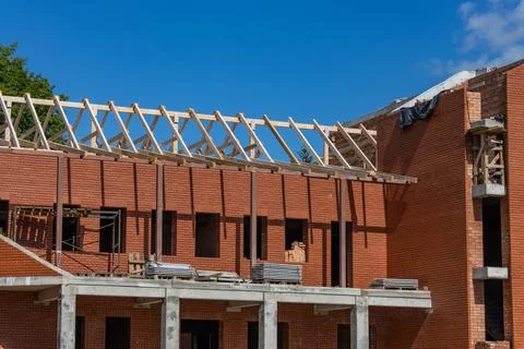 Construction of a large red brick Catholic church. Construction of a peaked r Stock Photos