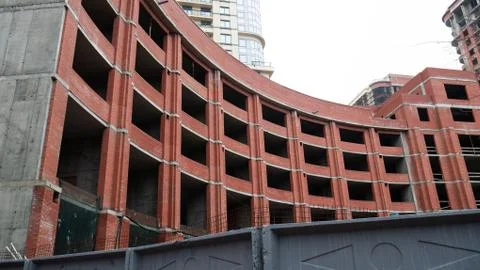 The construction of a large round brick building. Stock Photos