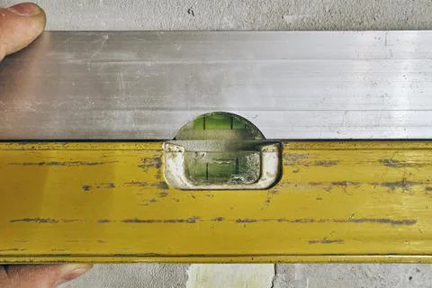 Construction level, a device for measuring the evenness of different objects. Stock Photos