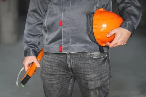 Construction level tool, safety glasses and protection helmet in the hand of a Stock Photos