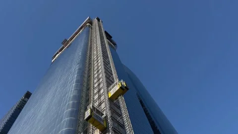 Construction lift moving on the side of the skyscraper 動画素材 167694563