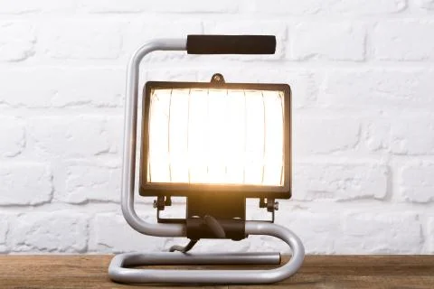 Construction light in front of brick wall Stock Photos