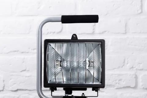 Construction light in front of brick wall Stock Photos