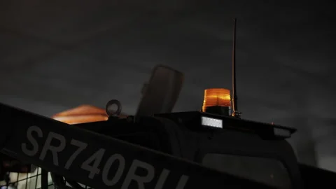 Construction loader warning beacon flashing at night site Stock Footage 326064547
