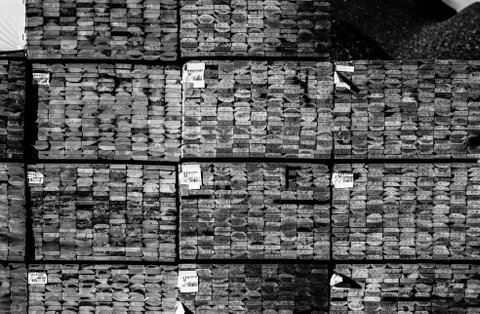 Construction lumber at the mill. Mill products. Black and white shot. Stock Photos