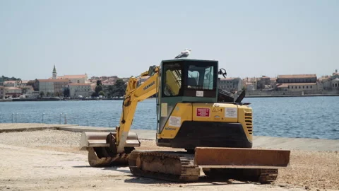 Construction machine on the beach, wide angle static shot. Stock Footage 132301249