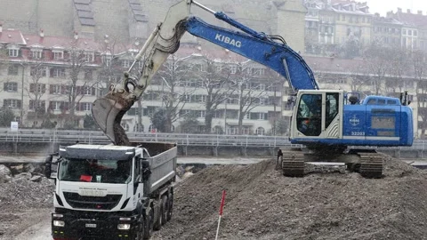 Construction machine digging and transporting, earthmoving activity Stock Footage 321708943