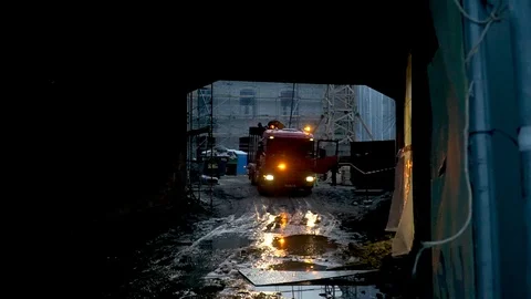 Construction machine with flashing lights stands at unloading Stock Footage 127057732