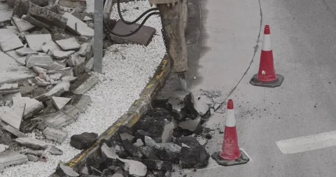 Construction Machine jackhammer breaking asphalt of the road Видео 141149128