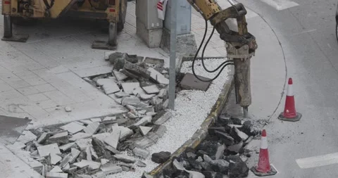 Construction Machine jackhammer breaking asphalt of the road Video stock 141151301