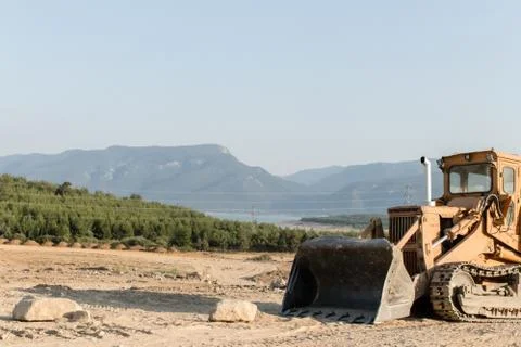 A construction machine was placed outside of city Stock Photos