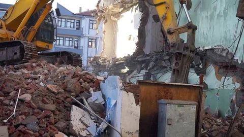 A construction machine working in the debris of the old building, 스톡 동영상 119892592