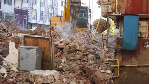 A construction machine working in the debris of the old building, Stock Footage 119892635