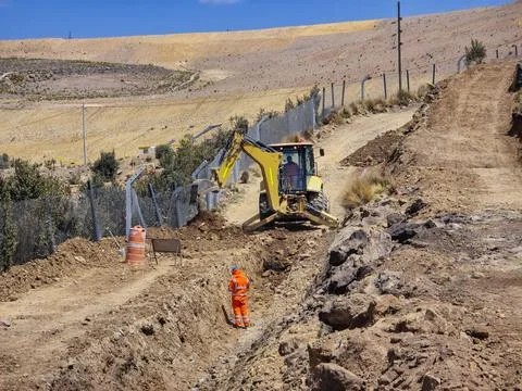 Construction machinery in the process of excavating a storm drain Foto stock