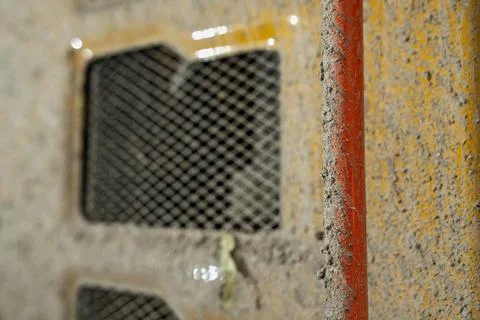 Construction machinery surface with dust-covered ventilation grid Foto stock