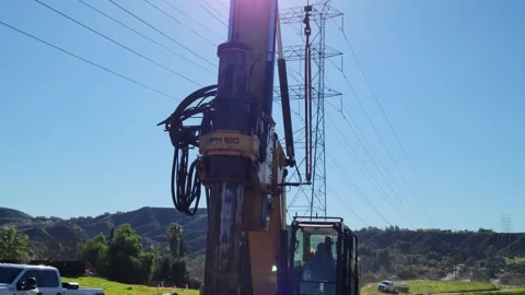 Construction Machinery under power lines tilt Stock Footage 231343924