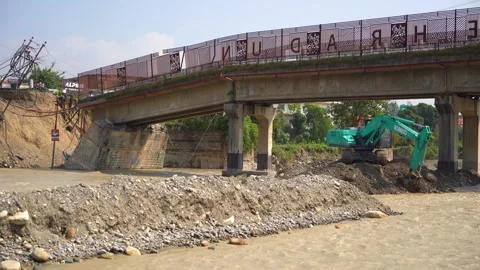 Construction machinery working during flood in India Stock Footage 321040994