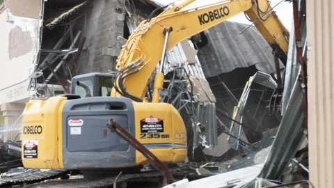Construction machines destroy a building excavator enters demolition site 스톡 동영상 125055402