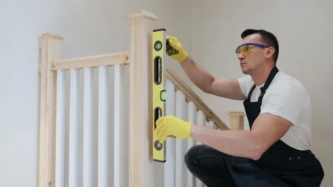 Construction male inspector check the vertical level of stairs by spirit level Stockbeeldmateriaal 133359126