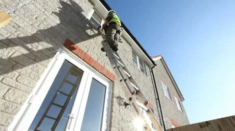 Construction. Man cleaning windows Video stock 10728846
