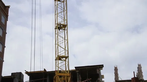 Construction. Man climbs up on crane. Video stock 53824840