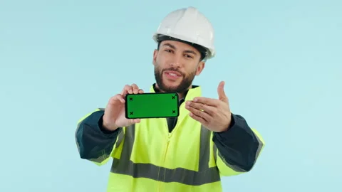 Construction man, green screen and show phone in studio, app promo and face by Stock Footage 250203584